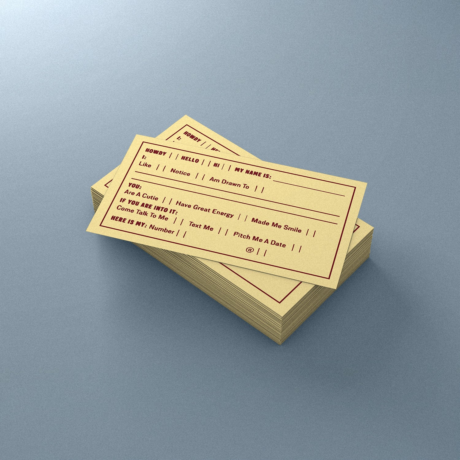 Stack of yellow dating cards on a gray background